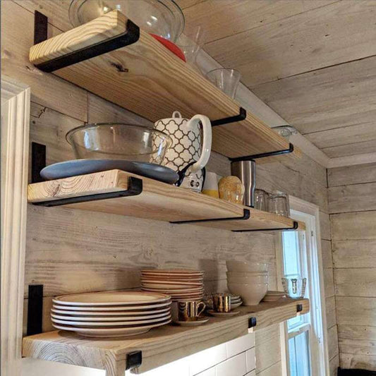 Black iron wall-mounted shelf support bracket holding a wooden plank shelf