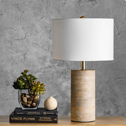 Retro simple decorative solid wood table lamp glowing on a wooden nightstand