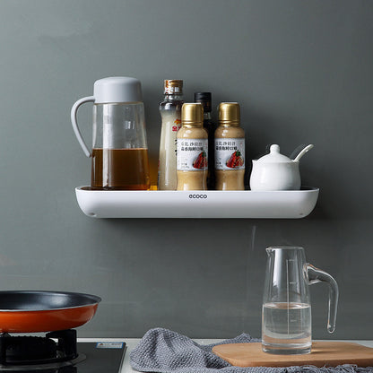 Wall mounted bathroom and kitchen storage rack holding toiletries on tile wall