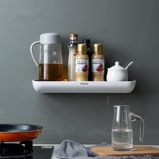 Wall mounted bathroom and kitchen storage rack holding toiletries on tile wall